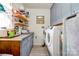 Laundry room with washer, dryer, and overhead storage cabinets at 109 Ashley St, Shelby, NC 28150
