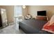 Comfortable bedroom featuring a bed, desk, mirror, and large window at 11121 Sevilla Ct, Charlotte, NC 28226