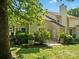 Rear exterior view of the home, complimented by mature shade trees and lush landscaping at 11121 Sevilla Ct, Charlotte, NC 28226