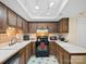 View of the kitchen with wooden cabinets, tile countertops, and modern appliances at 11121 Sevilla Ct, Charlotte, NC 28226