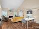 Open-concept living room featuring a fireplace, vaulted ceilings, and ample natural light at 11121 Sevilla Ct, Charlotte, NC 28226