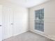 Bright bedroom featuring neutral carpet, large window, and modern trim work at 112 Brookshire Dr, Fort Mill, SC 29715