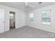 Spacious bedroom with neutral carpet, ceiling fan, and natural light from three windows at 112 Brookshire Dr, Fort Mill, SC 29715