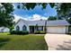 Charming one-story home with a well-manicured lawn and attached two-car garage at 112 Brookshire Dr, Fort Mill, SC 29715