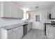 Well-lit kitchen features white cabinets, granite countertops, and modern appliances at 112 Brookshire Dr, Fort Mill, SC 29715