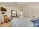 Cozy bedroom with a ceiling fan, a comfortable bed, and a decorative mirror, perfect for relaxation at 115 Pine Grove Cir, Clover, SC 29710
