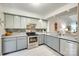 Well-lit kitchen features stone backsplash, stainless steel appliances, and light grey cabinetry at 115 Pine Grove Cir, Clover, SC 29710