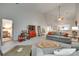 Open living space featuring vaulted ceilings and light gray flooring that seamlessly connects to the dining area at 115 Pine Grove Cir, Clover, SC 29710