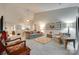 Spacious living room with high ceilings and light gray floors, open to the dining area, creating an inviting space at 115 Pine Grove Cir, Clover, SC 29710
