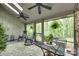 Relaxing sunroom with a ceiling fan, lots of plants and comfortable seating to enjoy the outdoors at 115 Pine Grove Cir, Clover, SC 29710