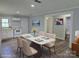 Bright dining room featuring a modern table with seating for four and an open view to the kitchen at 1150 Shue Rd, China Grove, NC 28023
