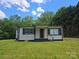 Charming single-story home featuring gray siding, black shutters, and a well-maintained lawn at 1150 Shue Rd, China Grove, NC 28023