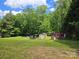 Large lot features multiple sheds, great for storage or workshop space at 1150 Shue Rd, China Grove, NC 28023