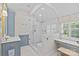 Bright bathroom featuring marble counters, custom cabinets, and luxurious glass shower at 1200 Rutledge Ave, Charlotte, NC 28211