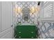 Stylish powder room with patterned wallpaper, green vanity, decorative mirror, and elegant lighting at 1200 Rutledge Ave, Charlotte, NC 28211