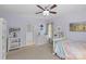 Cozy bedroom with pastel walls, plush carpet, ceiling fan, and adjacent bathroom at 1200 Rutledge Ave, Charlotte, NC 28211