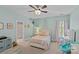Inviting aqua bedroom with plush carpet, ceiling fan, and adjacent bathroom at 1200 Rutledge Ave, Charlotte, NC 28211