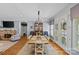 Bright dining room featuring hardwood floors, stone fireplace, and a large dining table with natural light at 1200 Rutledge Ave, Charlotte, NC 28211