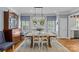 Charming dining area with a rustic table, elegant chandelier, and shuttered windows offering ample natural light at 1200 Rutledge Ave, Charlotte, NC 28211