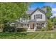 Charming two-story home with a landscaped yard, a covered entrance, and stylish architectural details at 1200 Rutledge Ave, Charlotte, NC 28211