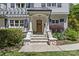 Inviting front porch with stone steps, white columns, and a wooden door adorned with a decorative wreath at 1200 Rutledge Ave, Charlotte, NC 28211