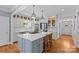 Spacious kitchen featuring an island, barstool seating, custom cabinetry, and stainless steel appliances at 1200 Rutledge Ave, Charlotte, NC 28211