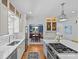 Bright and airy kitchen with white cabinets, a center island, and open access to the dining room at 1200 Rutledge Ave, Charlotte, NC 28211