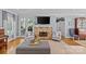 Inviting living room with a stone fireplace, comfortable seating, and French doors leading to the patio at 1200 Rutledge Ave, Charlotte, NC 28211