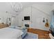 Bright living room boasts high ceilings, fireplace, hardwood floors and elegant chandelier at 1200 Rutledge Ave, Charlotte, NC 28211