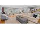 Open-concept living room seamlessly connects to the dining area and kitchen, with a large comfortable sofa at 1200 Rutledge Ave, Charlotte, NC 28211