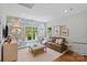 Cozy living room with a floral wallpapered accent wall, comfortable seating, and lots of natural light at 1200 Rutledge Ave, Charlotte, NC 28211