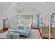Main bedroom featuring hardwood floors, sitting area, a decorative chandelier, and lots of natural light at 1200 Rutledge Ave, Charlotte, NC 28211