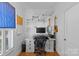 Well-lit home office with shelving, guitar mounts, and a comfortable workspace for productivity and creativity at 1200 Rutledge Ave, Charlotte, NC 28211