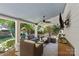 Covered outdoor patio featuring comfortable seating, a ceiling fan, and entertainment, overlooking the backyard play area at 1200 Rutledge Ave, Charlotte, NC 28211