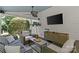 Relaxing covered patio with comfortable seating, TV, ceiling fan, and stylish decor for outdoor entertainment at 1200 Rutledge Ave, Charlotte, NC 28211