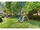 Backyard featuring a play set with slide, climbing wall, and swing set for outdoor fun at 1200 Rutledge Ave, Charlotte, NC 28211