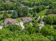 Aerial view of a home highlighting its well-manicured lawn, long driveway, and charming architecture at 12039 Lawings Corner Dr, Huntersville, NC 28078