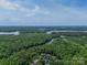Scenic aerial view of wooded area surrounding a lake and community, showcasing natural beauty at 12039 Lawings Corner Dr, Huntersville, NC 28078