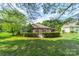 Beautifully landscaped backyard featuring a covered patio perfect for entertaining guests at 12039 Lawings Corner Dr, Huntersville, NC 28078