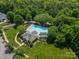 Aerial view of a community pool surrounded by lush greenery, and a clubhouse for recreation at 12039 Lawings Corner Dr, Huntersville, NC 28078