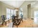Bright dining room with hardwood floors, stylish chandelier, and comfortable seating, perfect for entertaining at 12039 Lawings Corner Dr, Huntersville, NC 28078