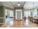 Inviting foyer with hardwood floors, stylish lighting, and a view into adjacent living and dining rooms at 12039 Lawings Corner Dr, Huntersville, NC 28078