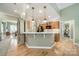 Well-appointed kitchen with modern appliances, sleek countertops, and breakfast bar, perfect for casual dining at 12039 Lawings Corner Dr, Huntersville, NC 28078
