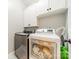 Well-equipped laundry room featuring a washer, dryer, and built-in cabinets for storage at 12039 Lawings Corner Dr, Huntersville, NC 28078