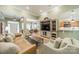 Open concept living room with hardwood floors, comfortable seating, and seamless connection to the dining area at 12039 Lawings Corner Dr, Huntersville, NC 28078