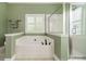 A luxurious bathroom featuring a soaking tub, a glass shower and serene paint at 12039 Lawings Corner Dr, Huntersville, NC 28078