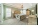 Serene bedroom features plush carpet, tray ceiling, and plenty of natural light for a peaceful retreat at 12039 Lawings Corner Dr, Huntersville, NC 28078