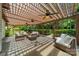 Relaxing outdoor patio with cozy seating under a shaded pergola, perfect for entertaining at 12039 Lawings Corner Dr, Huntersville, NC 28078