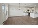 Dining room with hardwood floors, modern lighting, and an open layout with the kitchen and living areas at 15020 Meadows Hunt Ln # 159, Huntersville, NC 28078