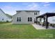 Two-story home in backyard featuring a gazebo and manicured lawn at 16337 Greybriar Forest Ln, Charlotte, NC 28278